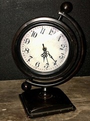 Table Clock, mantel or desk clock. Black metal. Round clock face On Tilt Stand